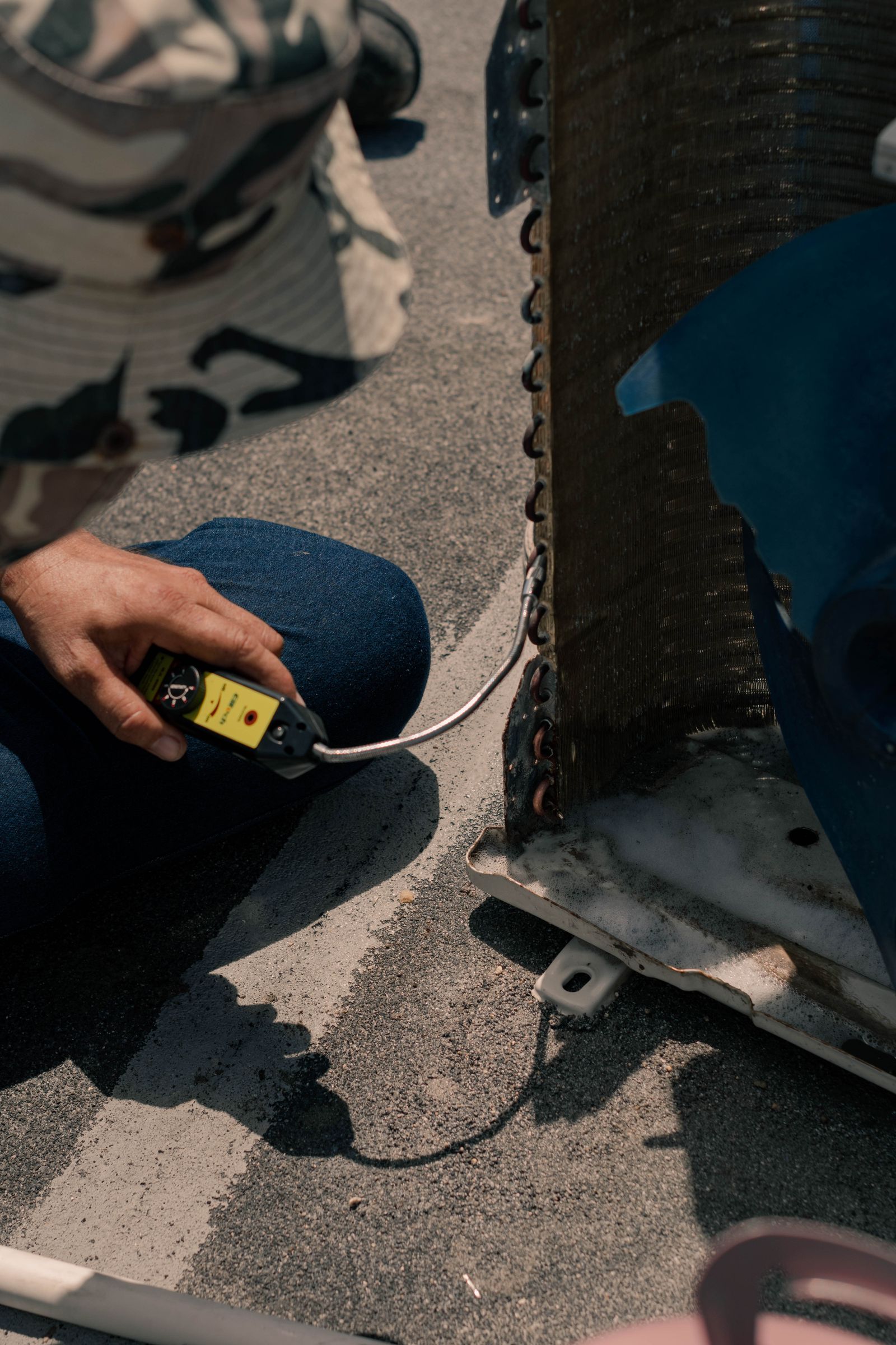 Illustrative technician servicing HVAC equipment